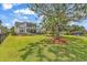 Expansive backyard with lush lawn, mature trees, and a play area at 1121 Glossy Ibis Dr., Conway, SC 29526