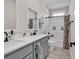 Updated bathroom boasts double vanity, a framed mirror, and a shower with tile surround at 1121 Glossy Ibis Dr., Conway, SC 29526