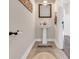 Cozy powder room featuring pedestal sink, patterned tile floor, and bronze fixtures at 1121 Glossy Ibis Dr., Conway, SC 29526