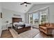 Cozy bedroom with hardwood floors, high ceilings, large windows, and comfortable seating area at 1121 Glossy Ibis Dr., Conway, SC 29526