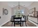 Bright dining room featuring hardwood floors, vaulted ceilings, and large windows offering picturesque views at 1121 Glossy Ibis Dr., Conway, SC 29526