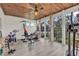 Bright exercise room features wood ceilings, walls of windows, and assorted workout equipment at 1121 Glossy Ibis Dr., Conway, SC 29526