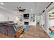 Spacious living room with hardwood floors, built-in shelving, a cozy fireplace, and sliding glass doors at 1121 Glossy Ibis Dr., Conway, SC 29526