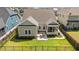 Aerial view of a home's backyard featuring a patio with a dining table, lush lawn, and wrought iron fence at 1127 East Isle Of Palms Ave., Myrtle Beach, SC 29579