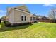 Exterior of the backyard featuring green lawn and a screened porch with patio furniture at 1127 East Isle Of Palms Ave., Myrtle Beach, SC 29579