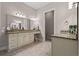 Well-lit bathroom features double vanity with granite countertops, neutral colors, and tile flooring at 1127 East Isle Of Palms Ave., Myrtle Beach, SC 29579