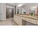 The bathroom boasts a granite countertop, a walk-in shower with glass door, and a large mirror at 1127 East Isle Of Palms Ave., Myrtle Beach, SC 29579
