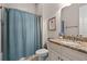 Cozy bathroom features vanity with granite countertops and a shower with blue curtains at 1127 East Isle Of Palms Ave., Myrtle Beach, SC 29579