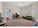 Bright bedroom space with a ceiling fan, desk, and green sofa at 1127 East Isle Of Palms Ave., Myrtle Beach, SC 29579