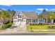 Inviting home with a cozy front porch, lush green lawn, and convenient two-car garage at 1127 East Isle Of Palms Ave., Myrtle Beach, SC 29579