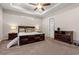 Spacious main bedroom with dark wood furniture, a ceiling fan, and carpeted floor at 1127 East Isle Of Palms Ave., Myrtle Beach, SC 29579