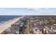 Stunning aerial view of a charming beach neighborhood near the ocean and pier with palm trees at 1210 N Ocean Blvd. # 105, Surfside Beach, SC 29575