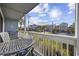 Relax on this balcony with coastal community views and comfortable outdoor seating at 1210 N Ocean Blvd. # 105, Surfside Beach, SC 29575