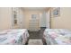 Inviting bedroom featuring twin beds, neutral tones, and ample closet space at 1210 N Ocean Blvd. # 105, Surfside Beach, SC 29575