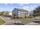 Condo building with three stories and multiple balconies, surrounded by palm trees at 1210 N Ocean Blvd. # 105, Surfside Beach, SC 29575