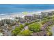 Aerial view of a condo complex with a beach in the background at 145 S Dunes Dr. # 109, Pawleys Island, SC 29585