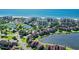 Aerial view of tennis courts, pool, lake, and houses near the beach at 145 S Dunes Dr. # 109, Pawleys Island, SC 29585