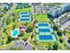 Aerial view of tennis courts, pool, and surrounding green space in a community at 145 S Dunes Dr. # 109, Pawleys Island, SC 29585