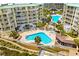 Aerial view of community pools surrounded by condo buildings and green space at 145 S Dunes Dr. # 109, Pawleys Island, SC 29585