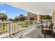 Relaxing balcony overlooking a pool area, offering comfortable seating and beautiful ocean vistas at 145 S Dunes Dr. # 109, Pawleys Island, SC 29585