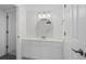 Modern bathroom with white cabinets, vanity, and a stylish round mirror at 145 S Dunes Dr. # 109, Pawleys Island, SC 29585