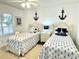 Bright bedroom featuring nautical themed decor and comfortable twin beds at 145 S Dunes Dr. # 109, Pawleys Island, SC 29585