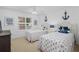 Charming bedroom with two twin beds, nautical decor, and ample natural light at 145 S Dunes Dr. # 109, Pawleys Island, SC 29585
