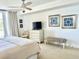 Tranquil bedroom featuring a serene color palette, a ceiling fan, and a private balcony at 145 S Dunes Dr. # 109, Pawleys Island, SC 29585