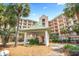 Beautiful condo complex featuring lush landscaping, manicured lawns, and a welcoming entrance at 145 S Dunes Dr. # 109, Pawleys Island, SC 29585