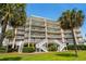 Beautiful beach condo building has balconies and outdoor staircases at 145 S Dunes Dr. # 109, Pawleys Island, SC 29585