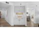 Bright hallway featuring a built-in bar with a decorative sign and access to the bedroom at 145 S Dunes Dr. # 109, Pawleys Island, SC 29585