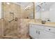 Bathroom featuring tiled shower with glass door, white vanity, and neutral tiling at 156 Henry Middleton Blvd., Myrtle Beach, SC 29588