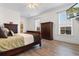 Bedroom featuring a wood bed, two dressers, wood flooring, a ceiling fan, and two windows at 156 Henry Middleton Blvd., Myrtle Beach, SC 29588
