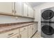 Laundry room with stacked washer/dryer, counter space, and upper and lower cabinets at 156 Henry Middleton Blvd., Myrtle Beach, SC 29588