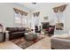 Open living room area features a gas fireplace, leather seating, and large windows with custom drapes at 156 Henry Middleton Blvd., Myrtle Beach, SC 29588