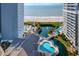 Expansive aerial view capturing beachfront condos, pristine beach access, and a complex pool and waterway layout at 161 Seawatch Dr. # 410, Myrtle Beach, SC 29572