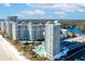 Stunning aerial view showcasing the pools, landscaping, and the oceanfront location of this community at 161 Seawatch Dr. # 410, Myrtle Beach, SC 29572