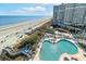 Captivating aerial view of a beachfront resort featuring a pool, boardwalk, and ocean access, ideal for relaxation at 161 Seawatch Dr. # 410, Myrtle Beach, SC 29572