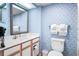 Well-lit bathroom featuring a vanity with a sink, a large mirror, and a toilet, providing a clean and functional space at 161 Seawatch Dr. # 410, Myrtle Beach, SC 29572