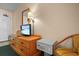 Bedroom showing a dresser with mounted TV and safety box with chair at 161 Seawatch Dr. # 410, Myrtle Beach, SC 29572