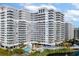 Exterior shot of a luxurious high-rise condo featuring private balconies, a pool, and scenic landscaping at 161 Seawatch Dr. # 410, Myrtle Beach, SC 29572