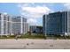 Exterior showcasing modern beachfront condos with inviting pools and manicured landscaping, providing a relaxing resort feel at 161 Seawatch Dr. # 410, Myrtle Beach, SC 29572