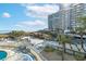 Scenic view of a resort pool area with a tiki bar, lounging area, and an ocean backdrop, perfect for relaxation at 161 Seawatch Dr. # 410, Myrtle Beach, SC 29572