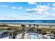 Inviting pool area with palm trees, a relaxing spa, and scenic beach views, ideal for a tranquil vacation at 161 Seawatch Dr. # 410, Myrtle Beach, SC 29572