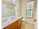 Bright bathroom features a single sink vanity, toilet, and tub-shower combo, as well as natural light from a window at 1612 Fairforest Ct., Conway, SC 29526