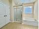 Bright bathroom featuring a glass shower, soaking tub, and neutral tile flooring at 1612 Fairforest Ct., Conway, SC 29526