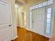 Well-lit foyer featuring hardwood floors, a decorative door, and interior access at 1612 Fairforest Ct., Conway, SC 29526