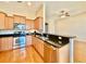 Well-equipped kitchen with stainless steel appliances, granite countertops, and wooden cabinets at 1612 Fairforest Ct., Conway, SC 29526