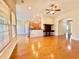 Open floor plan showing hardwood floors, a ceiling fan, and an opening to the kitchen at 1612 Fairforest Ct., Conway, SC 29526