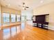 Bright living room with wood floors, a ceiling fan, and a built-in entertainment center at 1612 Fairforest Ct., Conway, SC 29526